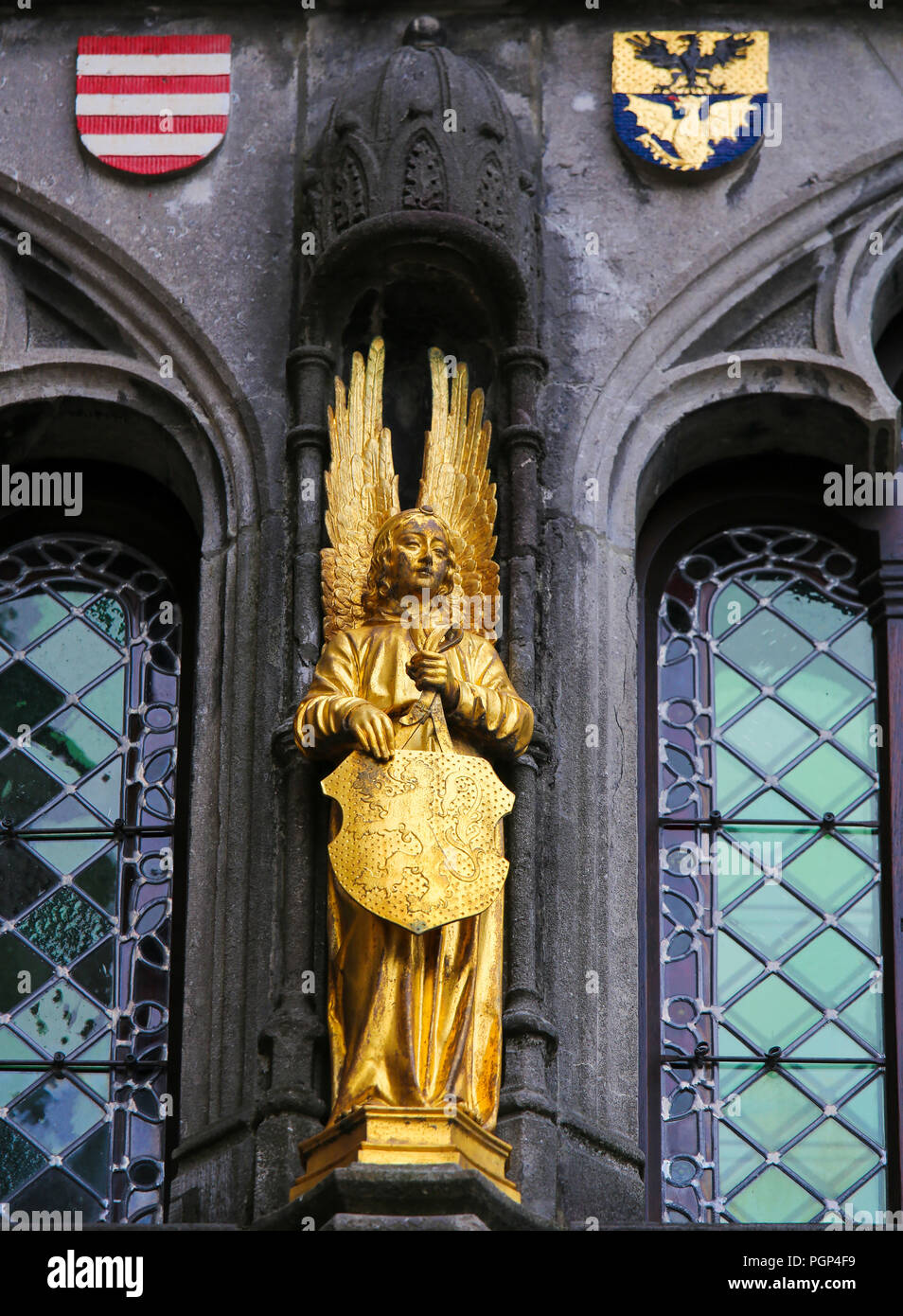 Statue at the Basilica of the Holy Blood in Bruges, of an Angel holding a shield with the Flemish Lion Stock Photo