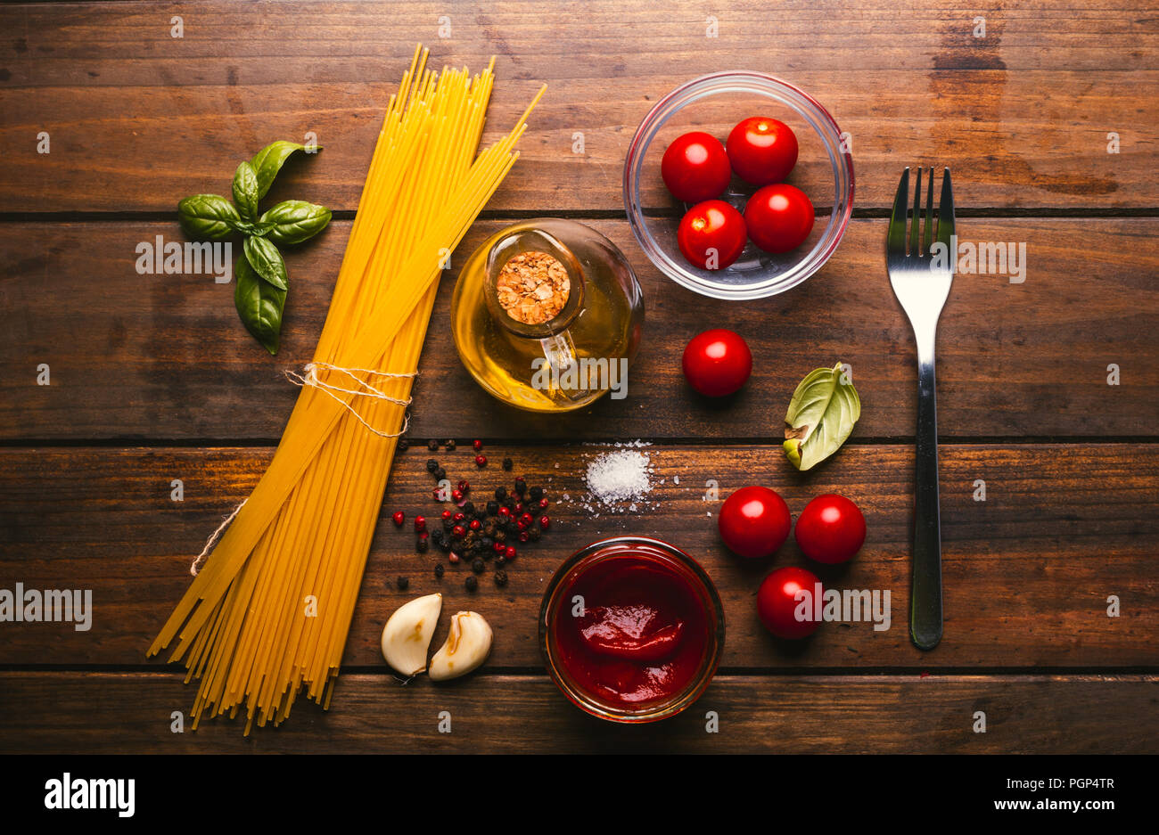 Pasta with various ingredients for cooking Italian food, on a rustic wooden table Stock Photo