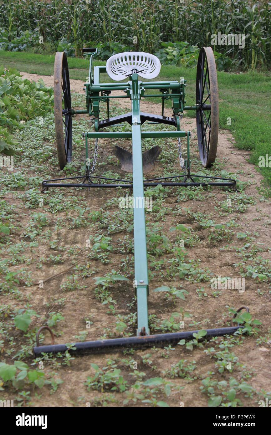 Vintage farm plow on display at the local Community Garden. Stock Photo