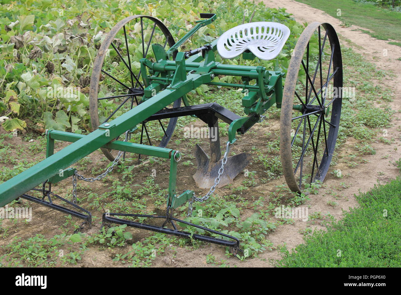 Vintage farm plow on display at the local Community Garden. Stock Photo