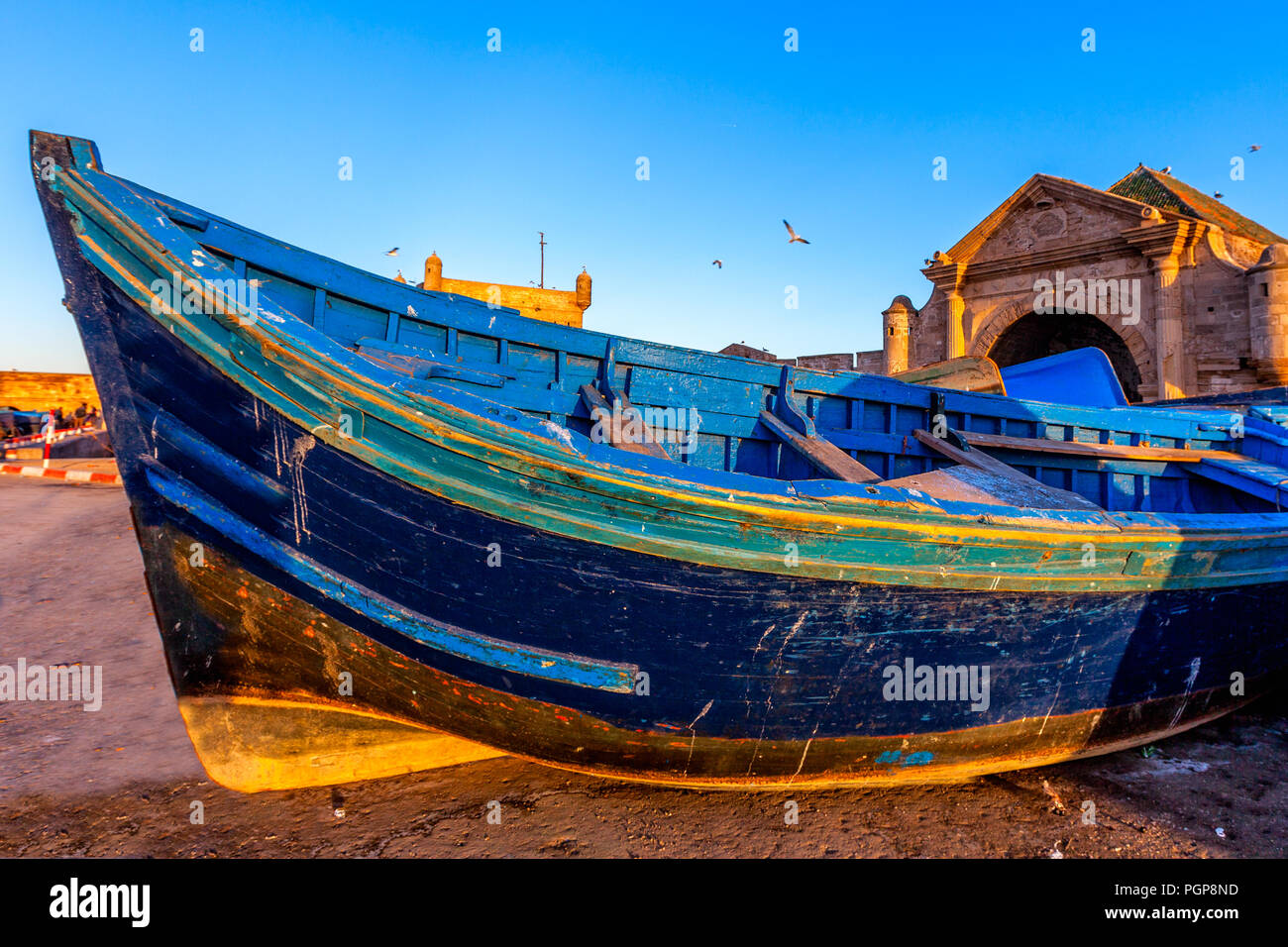 Morocco Essaouira, a picturesque coastal town on the Atlantic. Outside the fortified gates. Blue rowboat close up in the foreground. Copy space. Stock Photo
