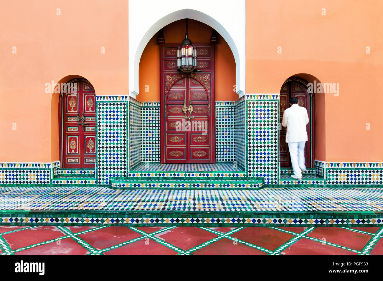 Moroccan tiled exterior with multiple arches and ornate painted doors of an elegant garden pavilion. Location: Marrakech hotel La Mamounia Stock Photo