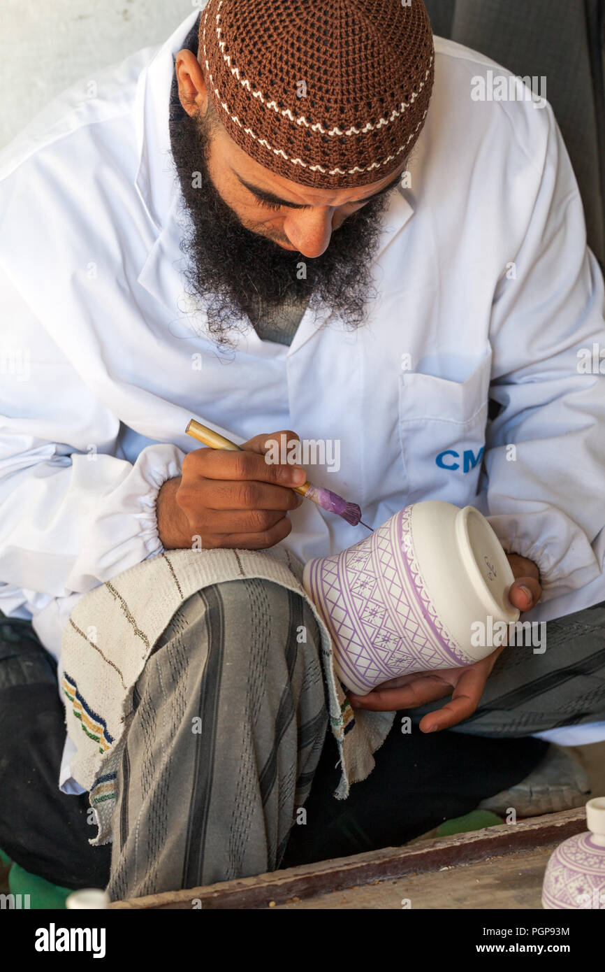 MOROCCO-Jan.3: A ceramic artist paints a design on a vase in Fez, Morocco on Jan. 3, 2013. Fez has been a center of fine pottery production for thousa Stock Photo