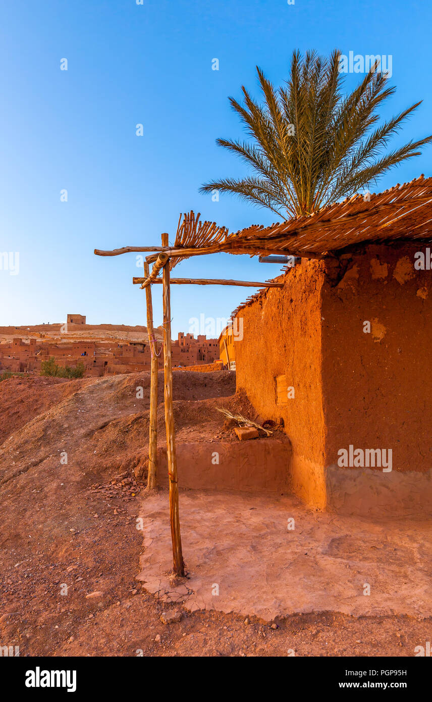 Moroccan mud house with palm tree Stock Photo