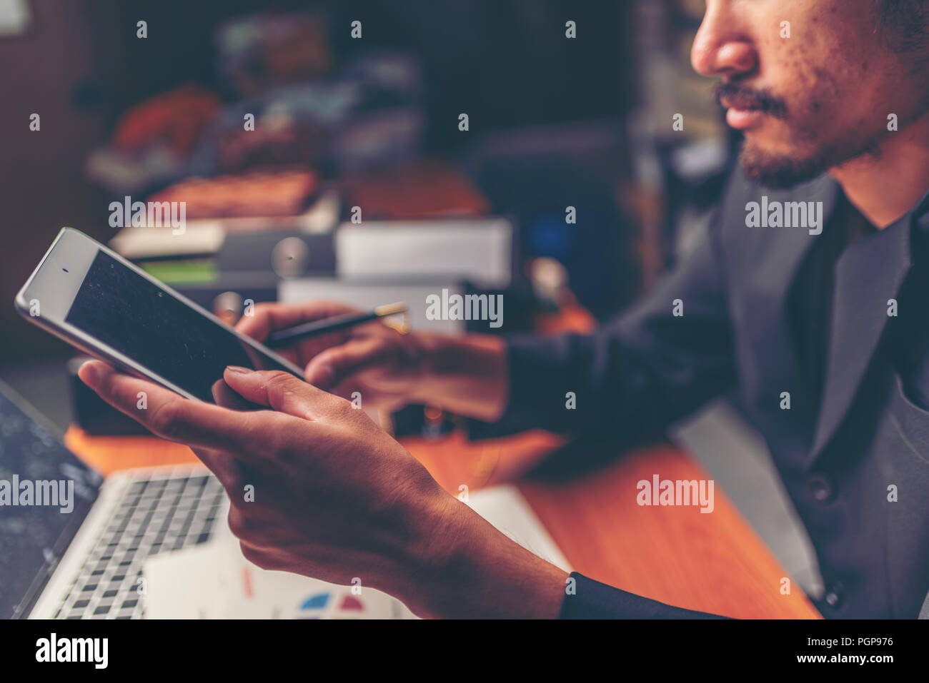 Businessmen are analyzed data from report using smartphone and laptop computer. Stock Photo