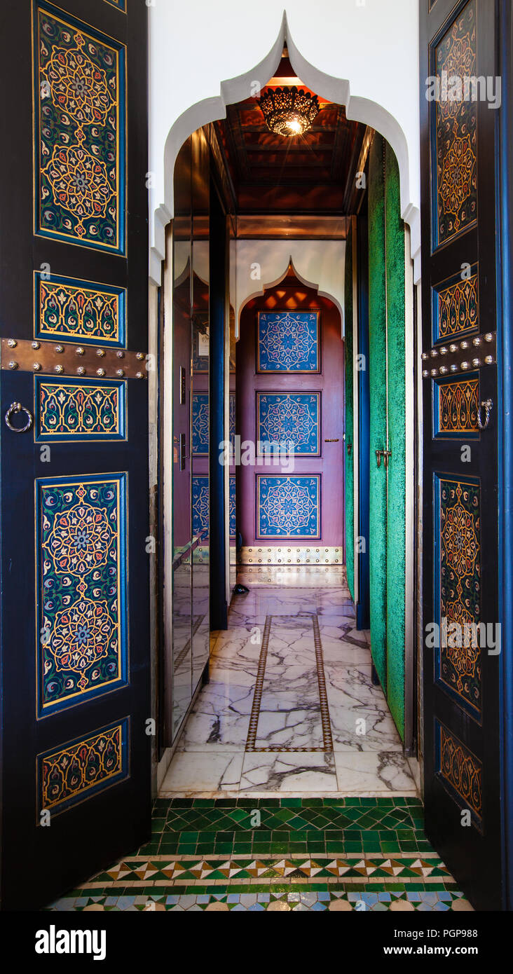 Moroccan beautiful painted doors and marble tiled hallway with mosaic flooring. Stock Photo