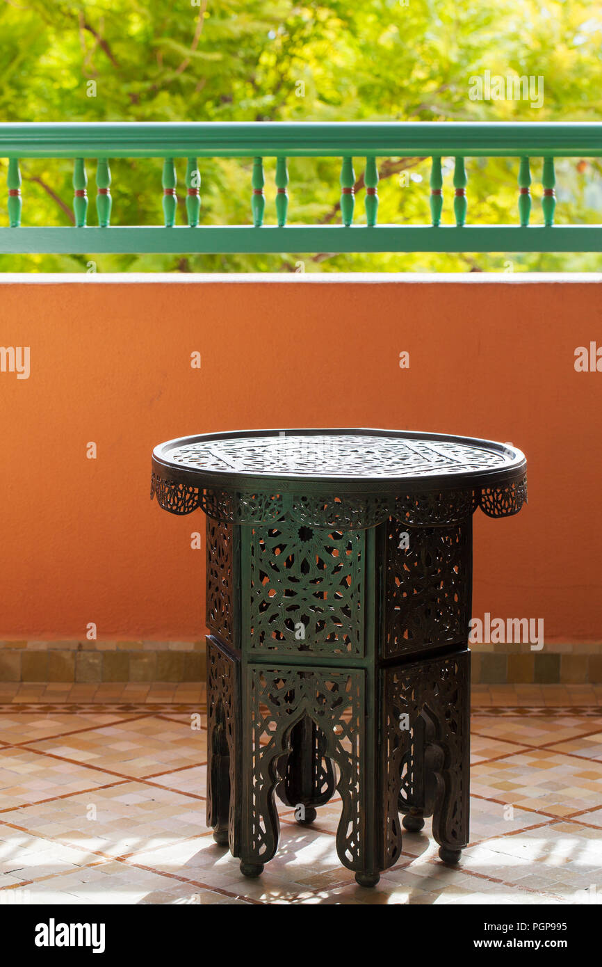 Morocco pierced metal design side table, with a hexagonal base and round top. Example of local Moroccan style. Location: Marrakech. Stock Photo