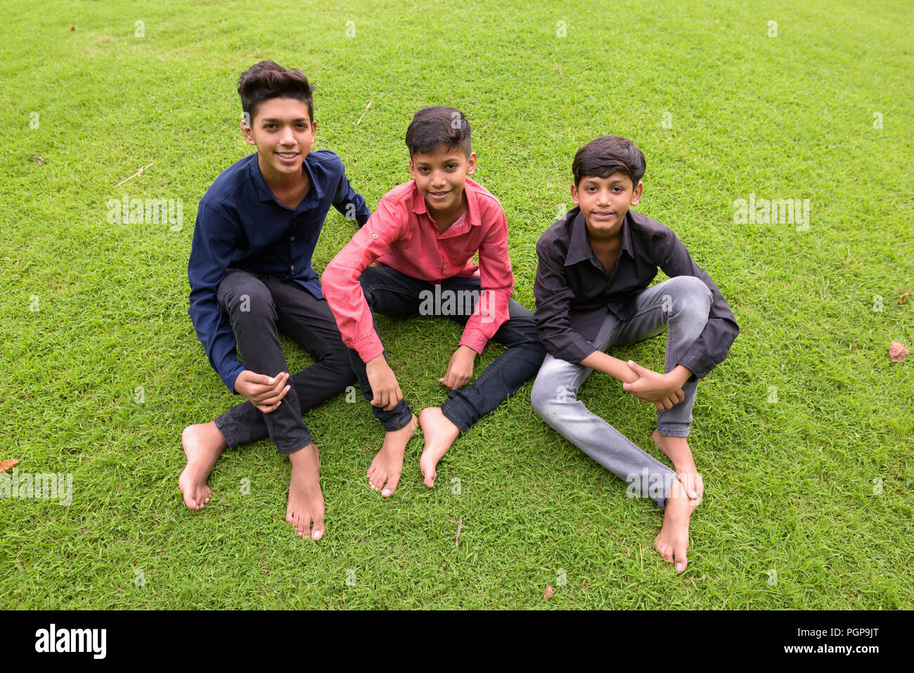 Portrait of Indian family relaxing together at the park Stock Photo