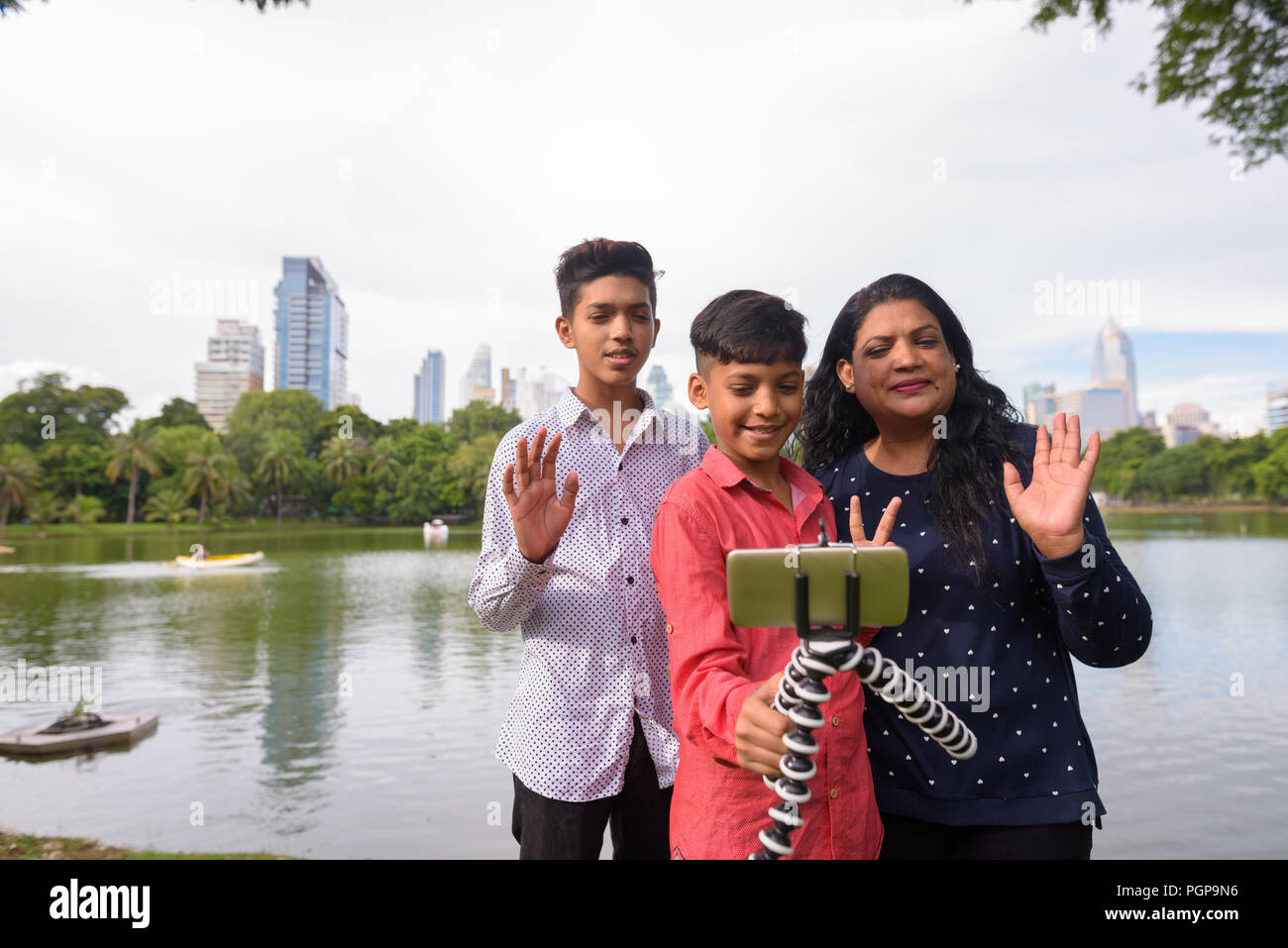 Portrait of Indian family relaxing together at the park Stock Photo