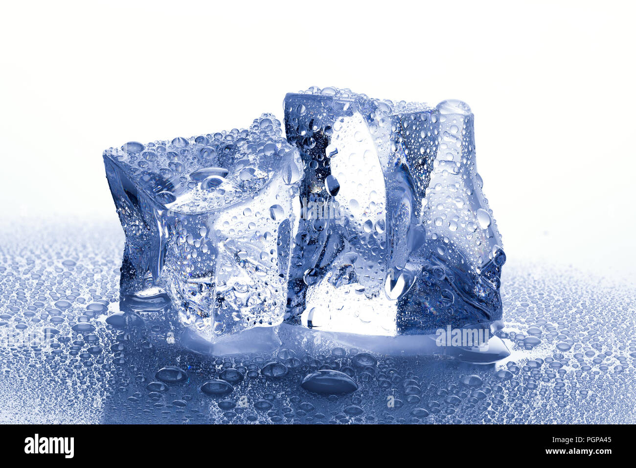 two ice cubes with water drops on white wet background Stock Photo