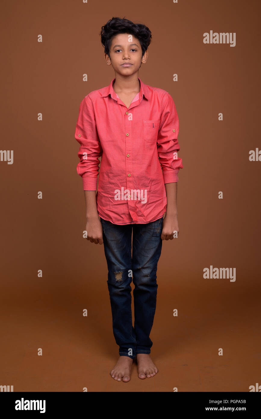 Young Indian boy wearing smart casual clothing against brown bac Stock  Photo - Alamy