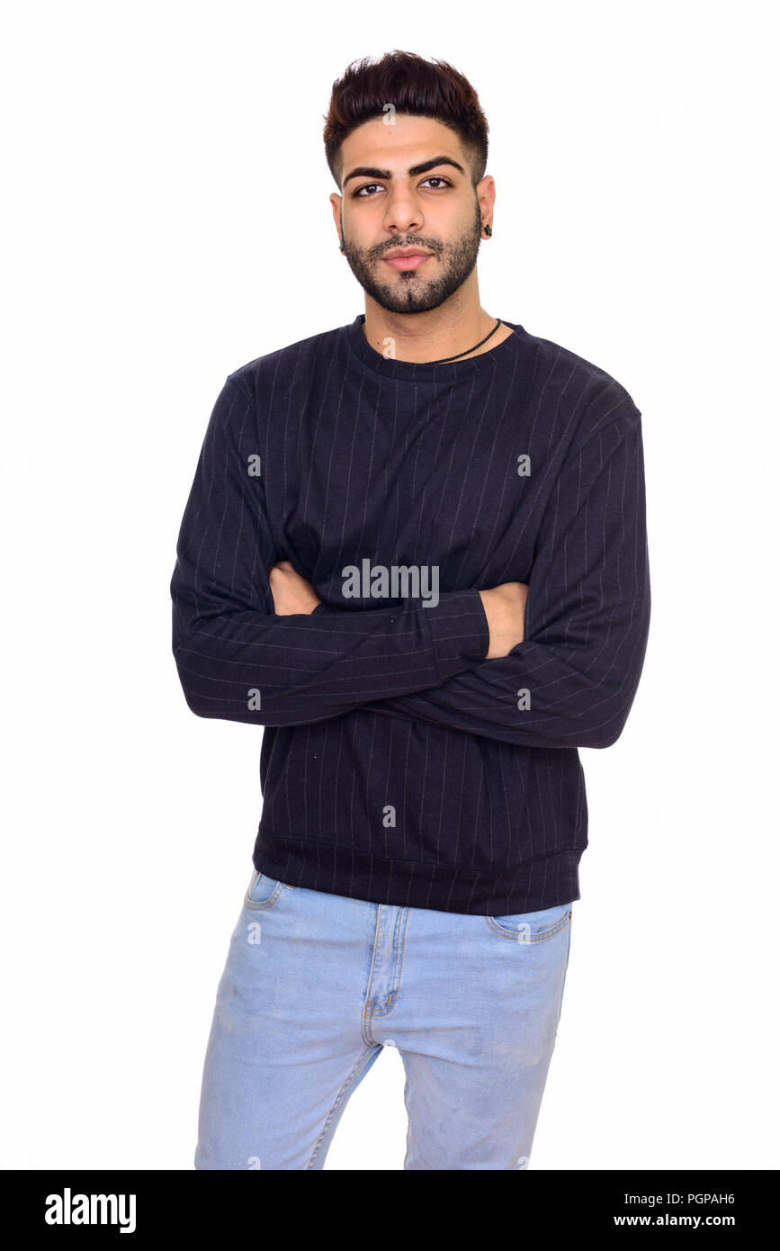 Studio shot of young handsome Indian man with arms crossed isola Stock ...