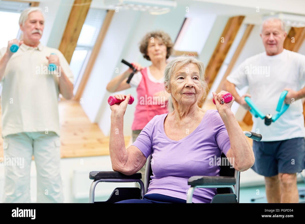 Old woman and seniors group in healthy dumbbell training in senior sport Stock Photo