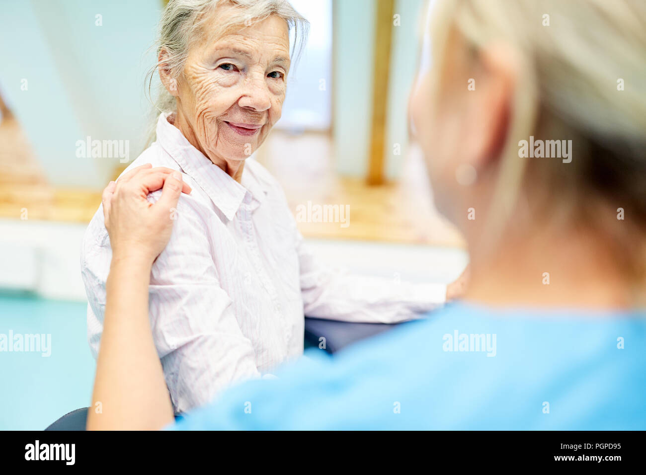 Nursing cares for a senior citizen as a patient with dementia Stock Photo