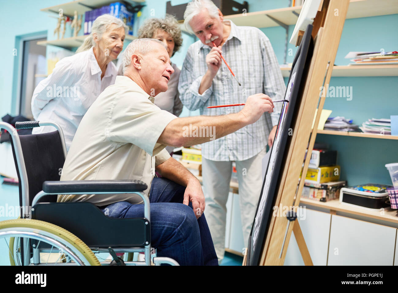 Seniors with dementia together in a creative painting class at the retirement home Stock Photo
