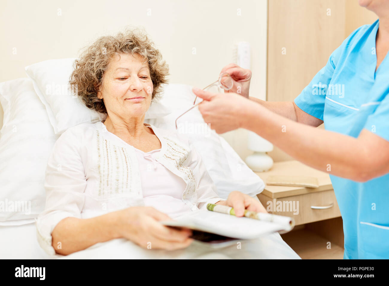 Caregiver Brings Glasses For Senior Woman As Patient In Hospital Or