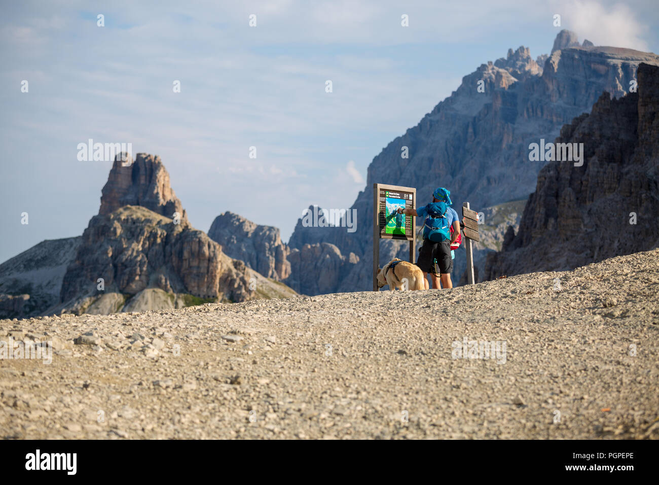Auronzo di Cadore, Dolomite, Italy - 08-25-2018: a guy on the top of the mountain looking at the map Stock Photo