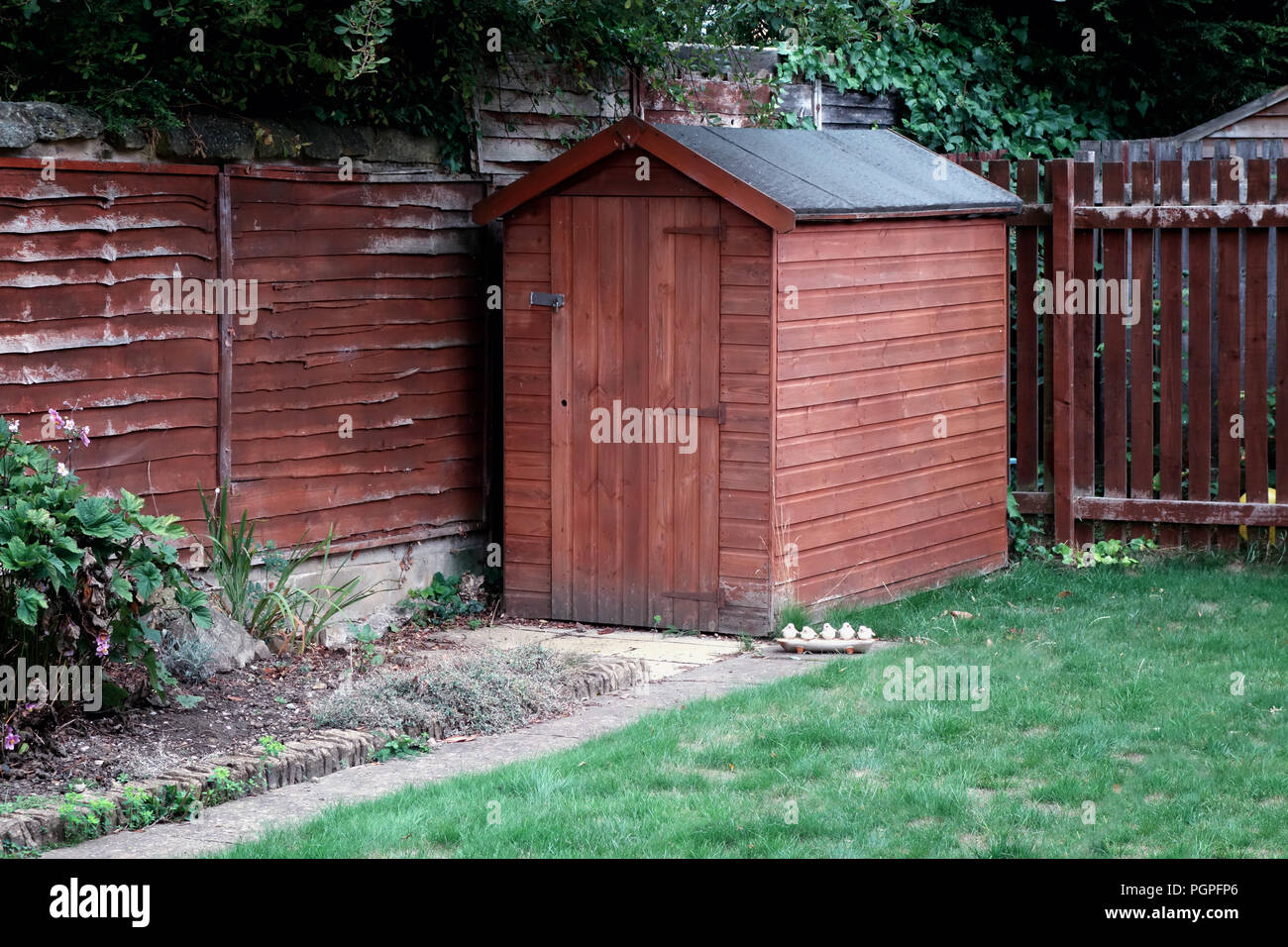 Small wooden garden shed the garden of a private house in Rotherham, South Yorkshire, England. Stock Photo