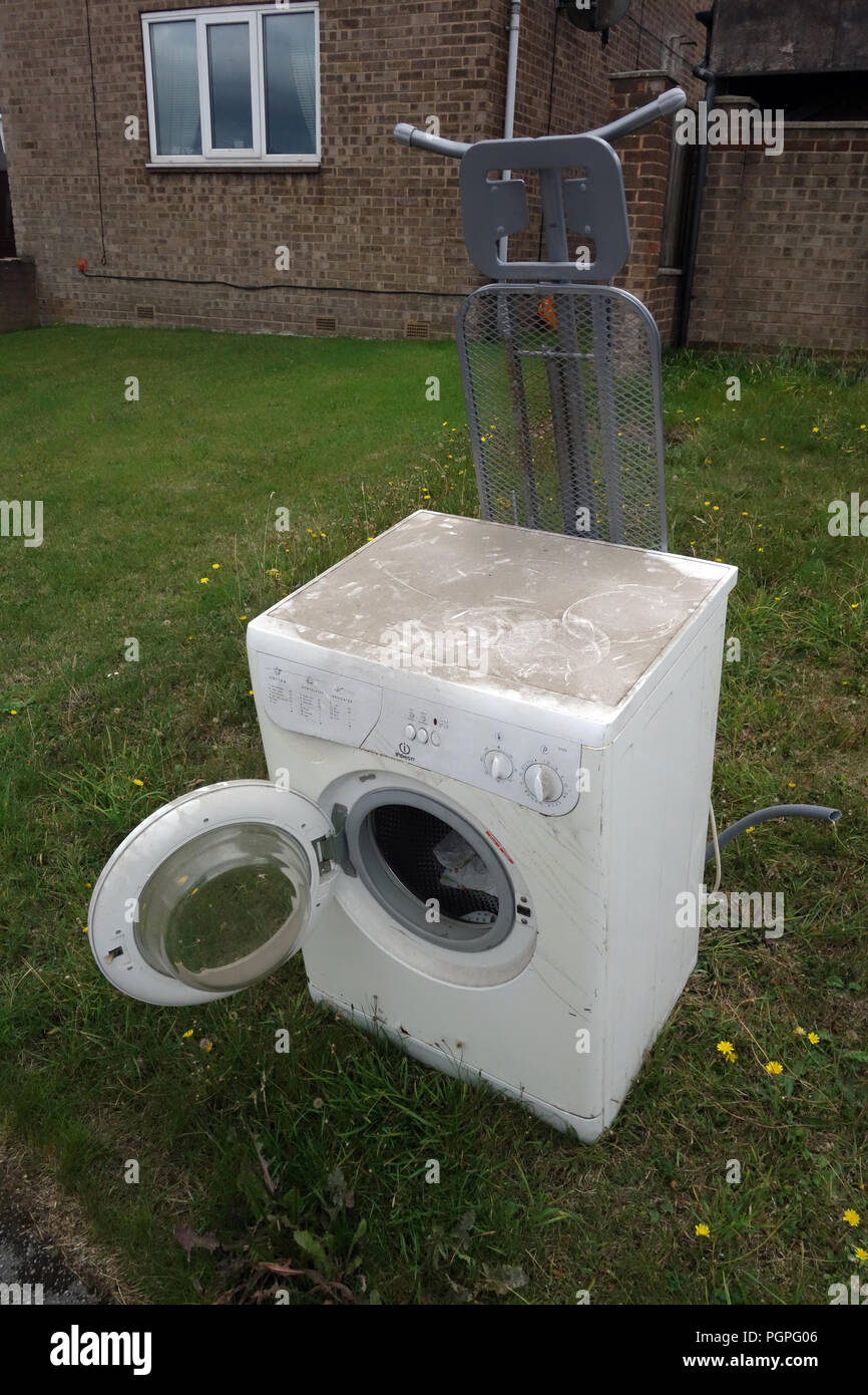Old unused washing machine and metal ironing board left out for the scrap  collector in Rotherham, South Yorkshire, England Stock Photo - Alamy