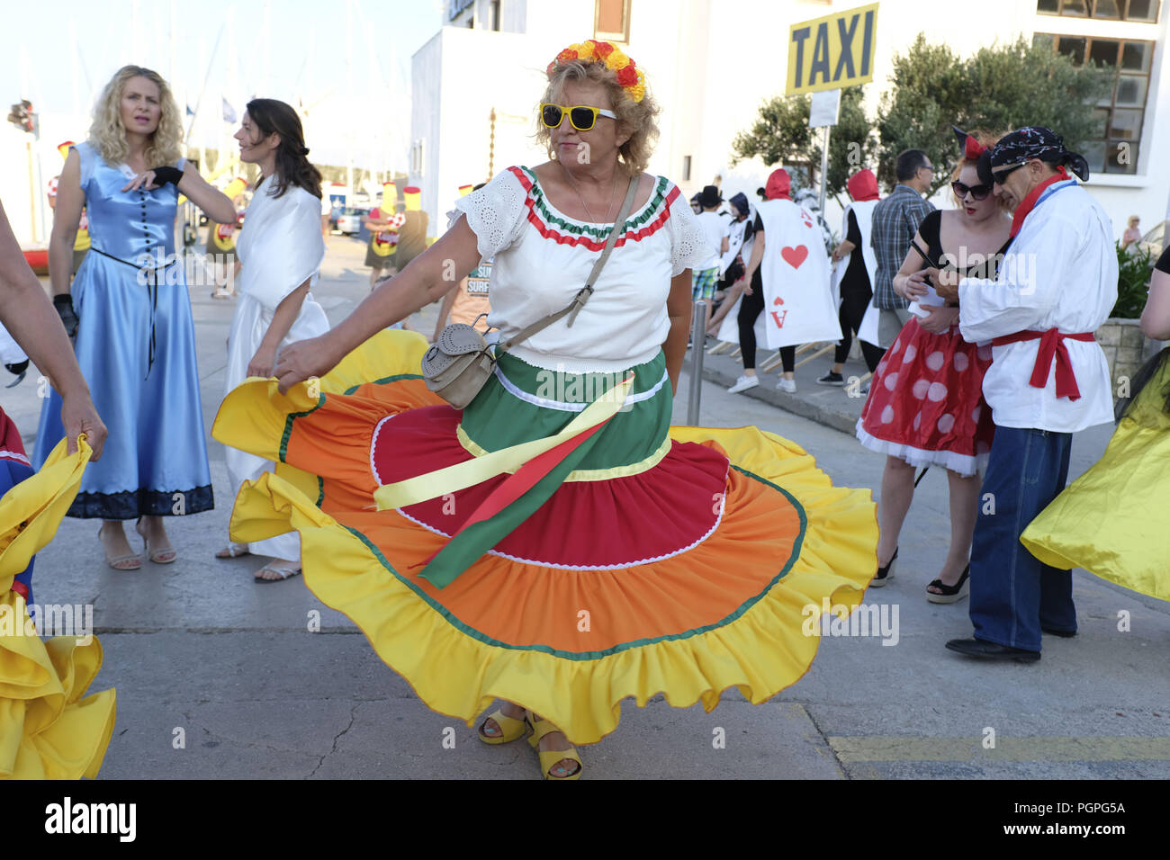 Korcula, Croatia. 30th June, 2018. A woman dressed up as a Mexican dancer  dances to flare her skirt in the street. Every year on June 30 the Croatian  island of Korcula celebrates
