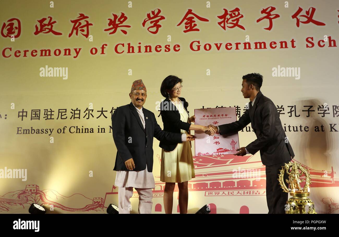 Kathmandu, Nepal. 27th Aug, 2018. Nepali Minister for Education, Science and Technology Giriraj Mani Pokharel (L) and Chinese Ambassador to Nepal Yu Hong (C) present a certificate to a Chinese government scholarship winner in Kathmandu, Nepal, Aug. 27, 2018. Around 160 Nepali students will study in Chinese universities for the 2018-2019 academic year under the Chinese government scholarship program. Credit: Sunil Sharma/Xinhua/Alamy Live News Stock Photo