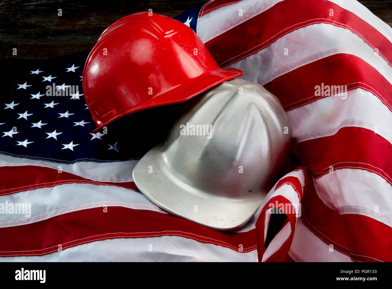 America at its greatest with flag and hard hats. Stock Photo
