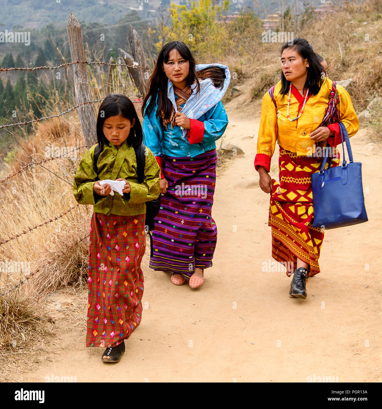 TRIMPHU, BHUTAN - MAR 8, 2017: Unidentified Ngalops people walk along