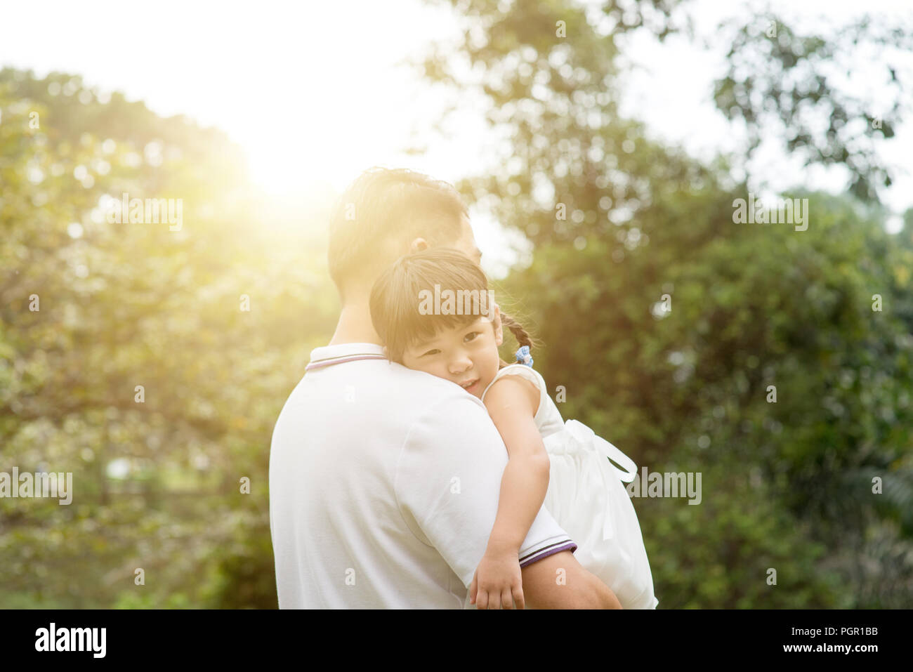Asian family outdoors portrait. Father and daughter at green park Stock ...