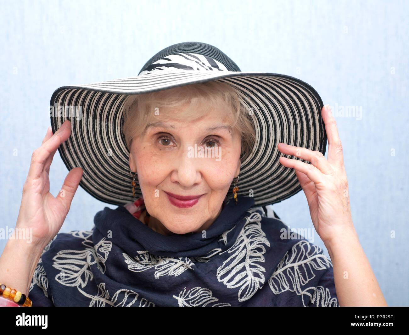 Senior female wearing hat posing in a good mood Stock Photo