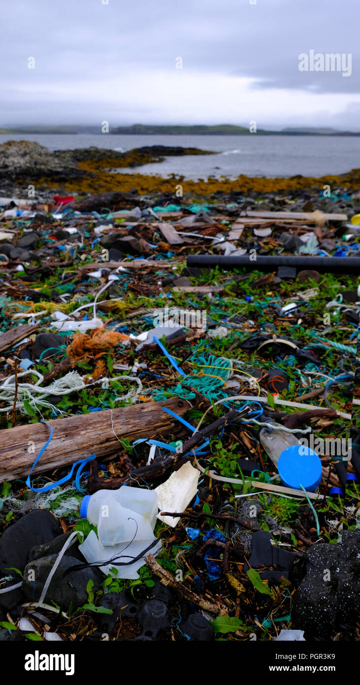 Plastic bottles, cans and containers washed up on the beautiful