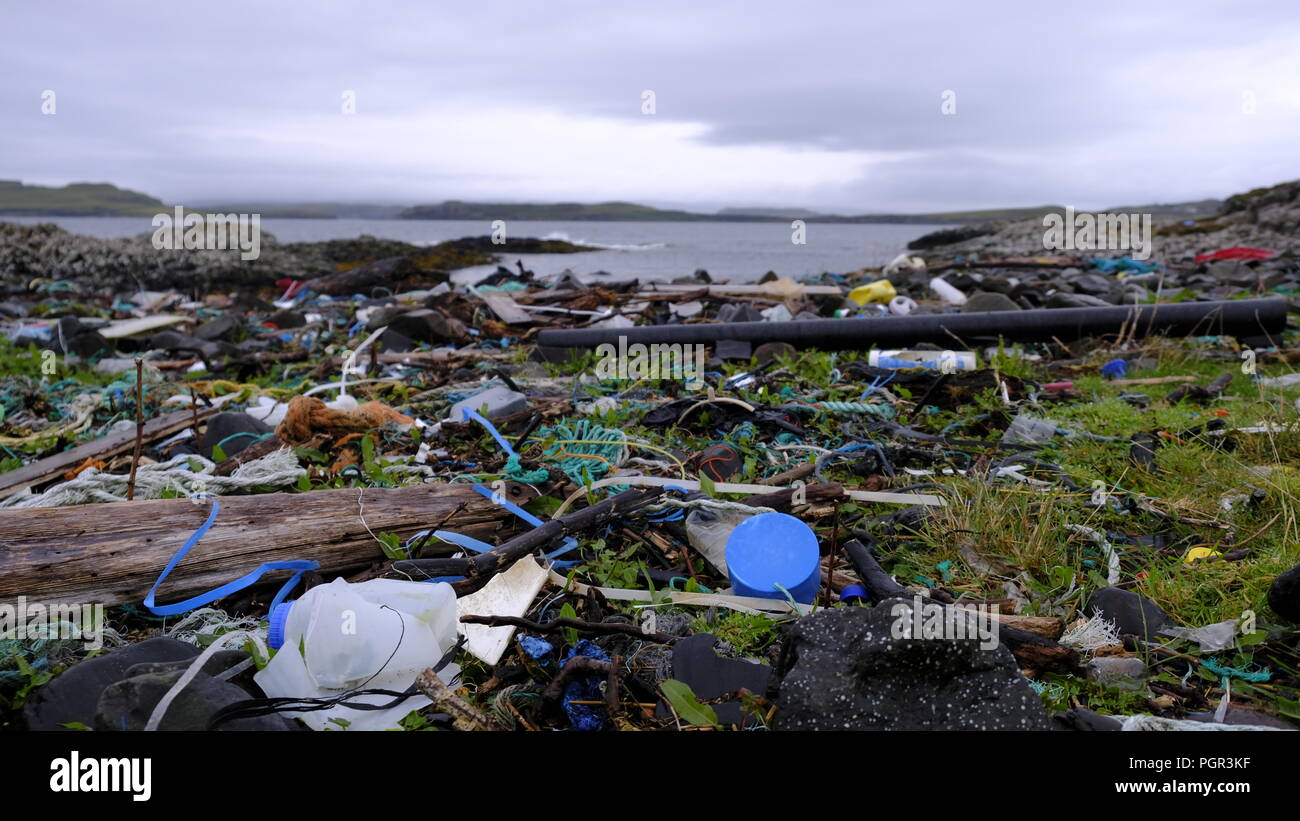 Plastic bottles, cans and containers washed up on the beautiful