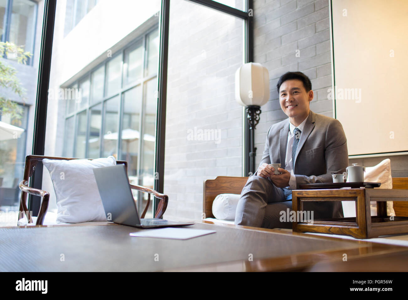 Confident businessman drinking tea Stock Photo