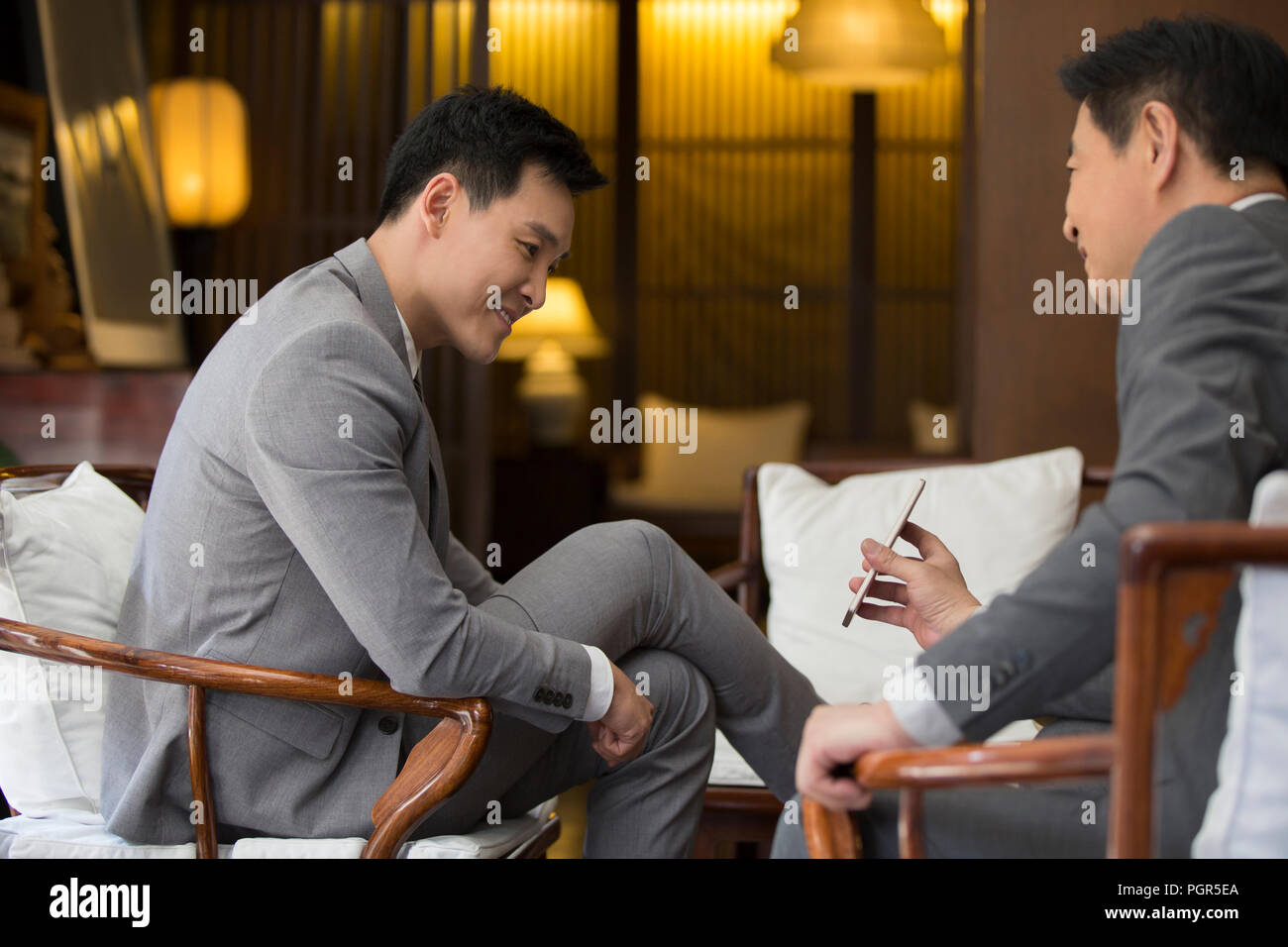 Cheerful businessmen using smart phone Stock Photo
