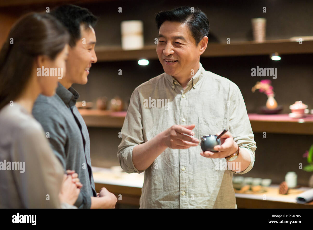 Man holding up teapot hires stock photography and images Alamy