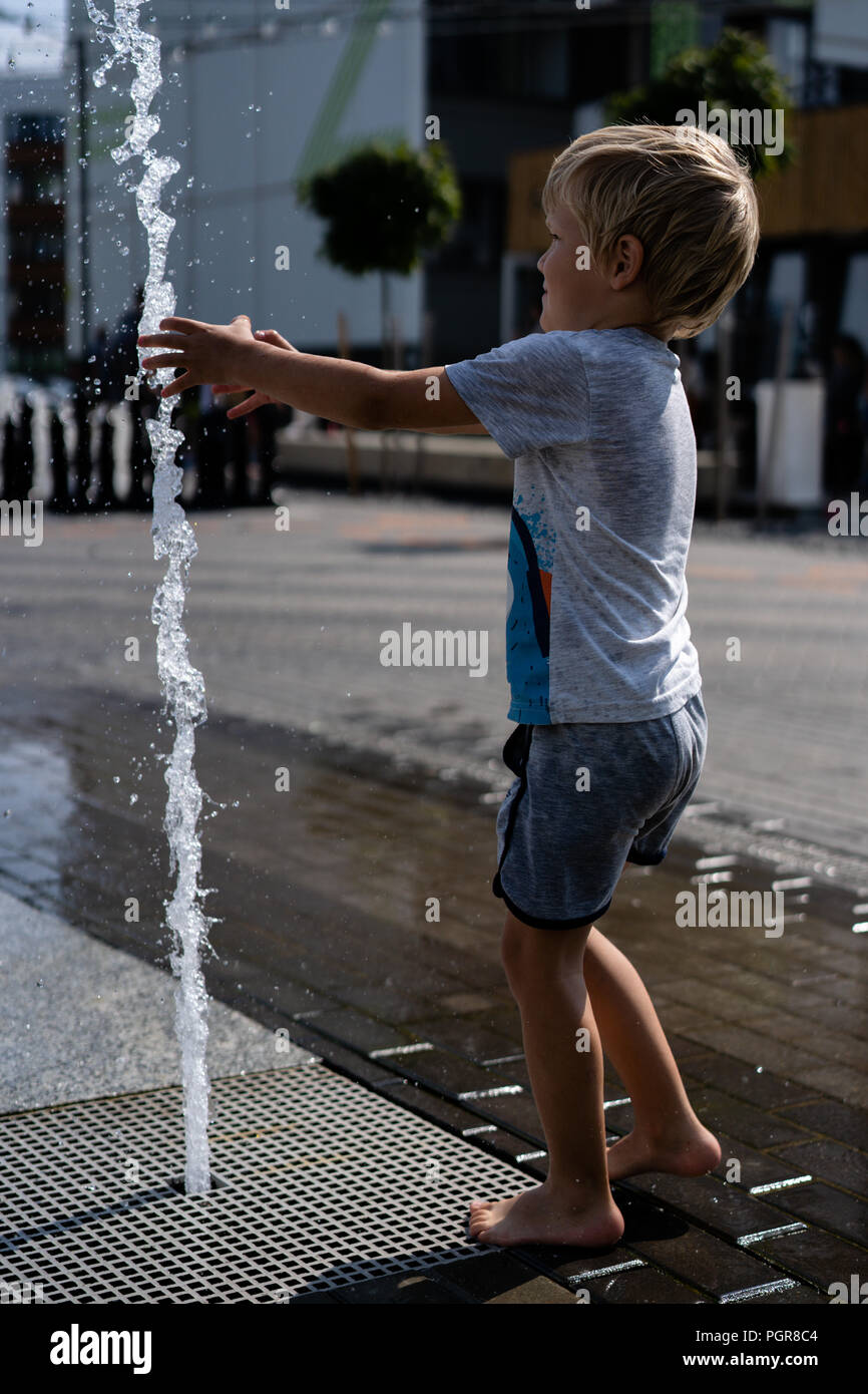 life of children in a modern city - little boy having fun with ...