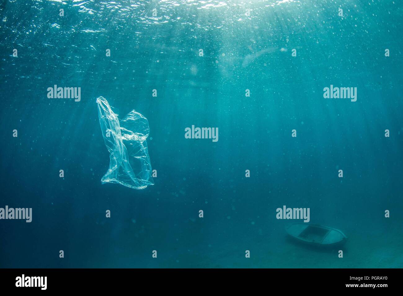 An underwater image of a plastic bag drifting in the ocean Stock Photo