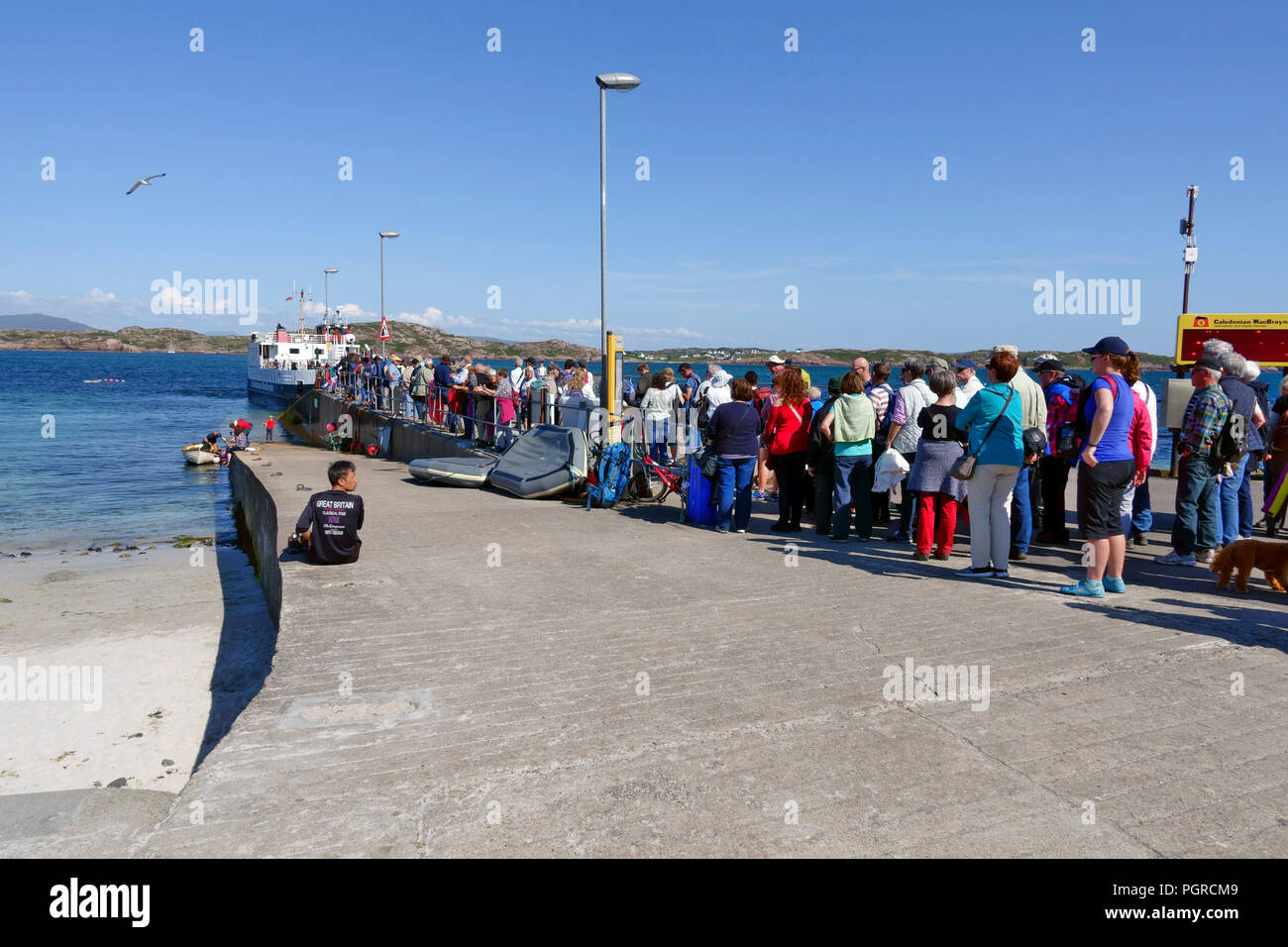 Queue of tourists and visitors leaving Iona on the Calmac ferry  to Fionnphort, Isle of Mull Stock Photo