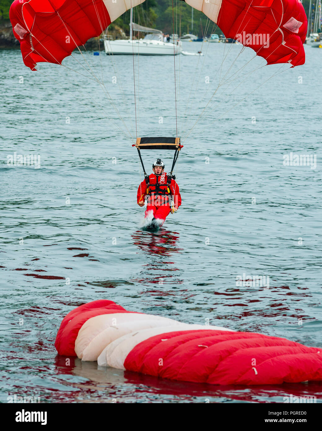 24/08/2018, Fowey, Cornwall, UK. Parachute diplay team The Red Devils make a low level jump into the Fowey River estuary at The Fowey Royal Regatta Stock Photo