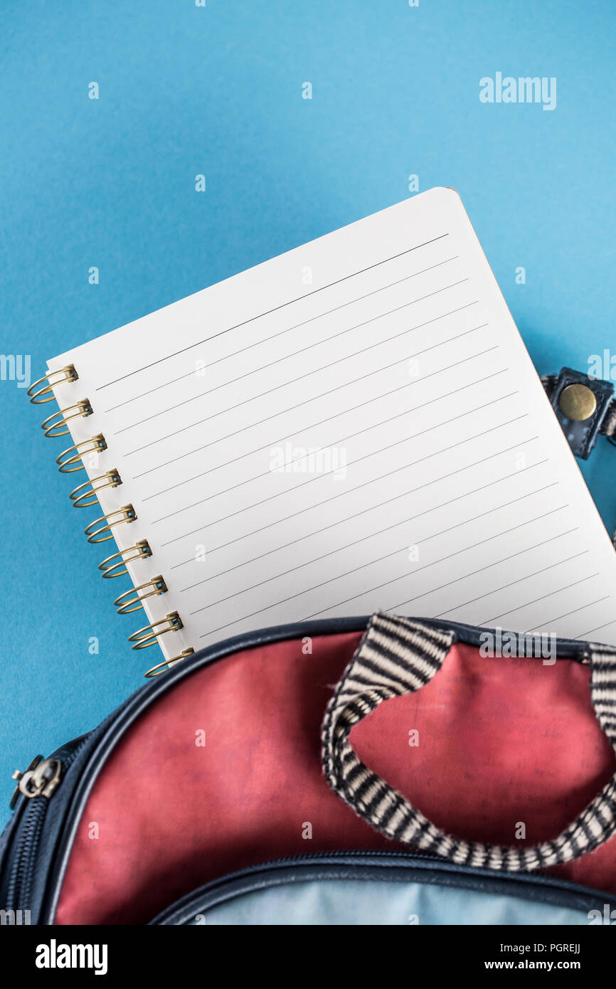 School backpack and notebook on blue background. Stock Photo