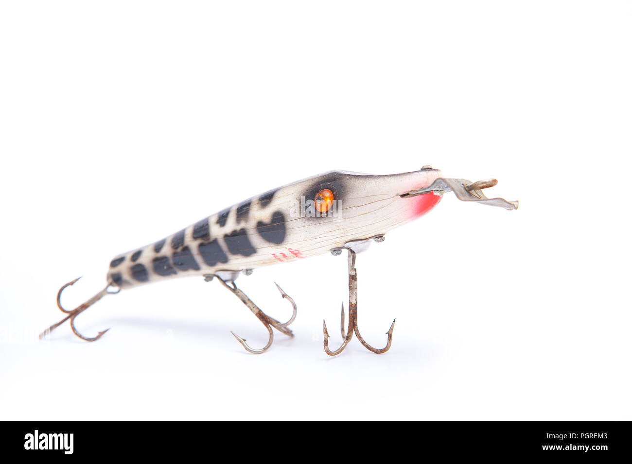 An old wooden Shakespeare fishing lure, or plug, equipped with three treble hooks and designed to dive whe it is reeled in. From a collection of vinta Stock Photo