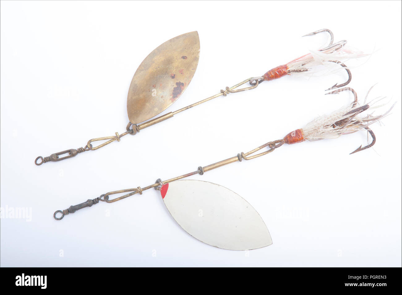 Vintage fishing lures equipped with treble hooks photographed on a