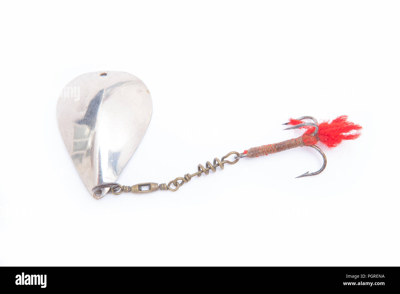 An old metal fishing lure designed for catching predatory fish equipped with a treble hook. From a collection of vintage and modern fishing tackle. No Stock Photo