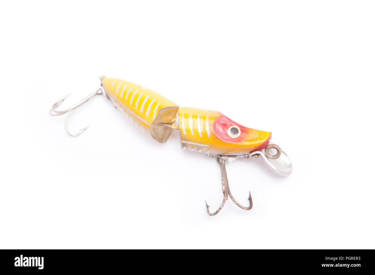 An old, jointed fishing lure, or plug, designed to dive when it is reeled in. From a collection of vintage and modern fishing tackle. North Dorset Eng Stock Photo