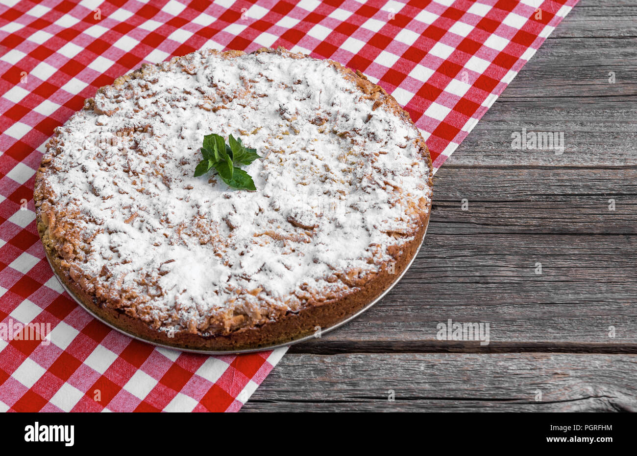 Homemade cake on a checkered tablecloth. Close-up. Stock Photo