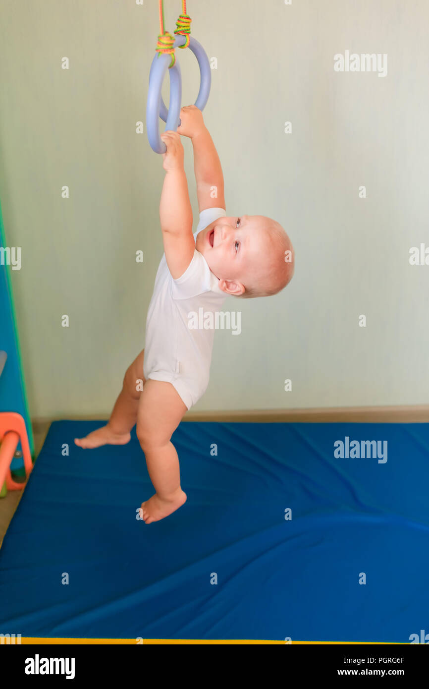 Cute Baby Boy Hanging On Rings On Home Wall Gym Baby Early Sportive Development Concept Stock Photo Alamy