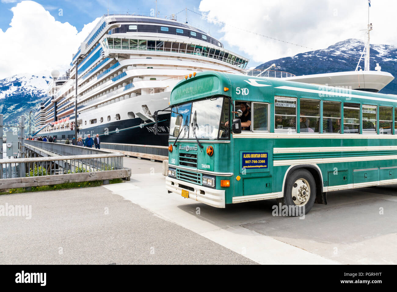 MS Nieuw Amsterdam and a tour bus in the harbour at Skagway, Alaska, USA Stock Photo
