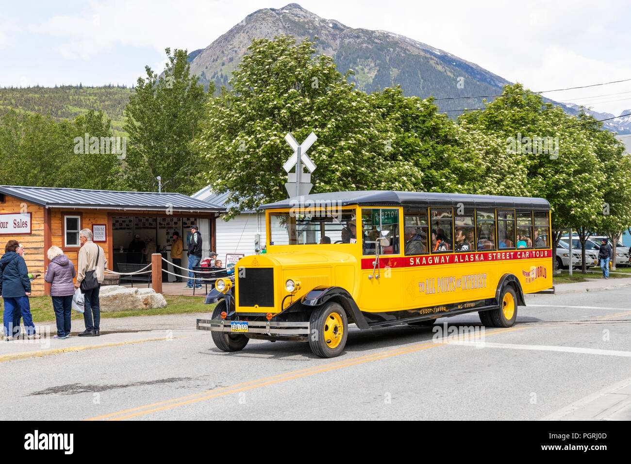 The yellow Skagway Alaska Street Car Tour bus in Skagway, Alaska, USA Stock Photo