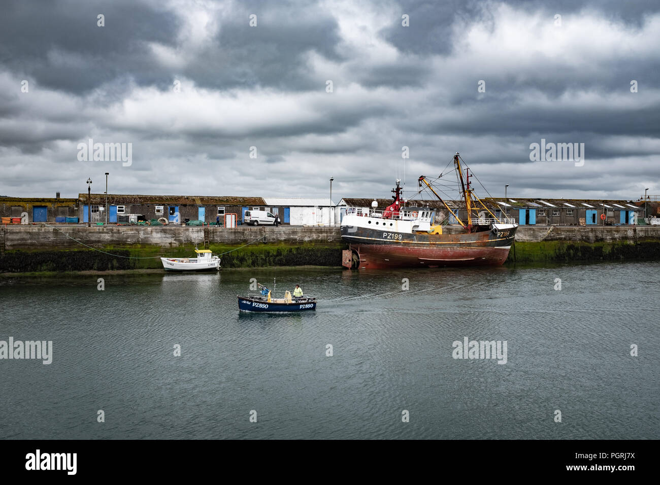 Small fishing boat returning to harbour, in Newlyn. In Newlyn, Cornwall, England. On 20th June 2018. Stock Photo