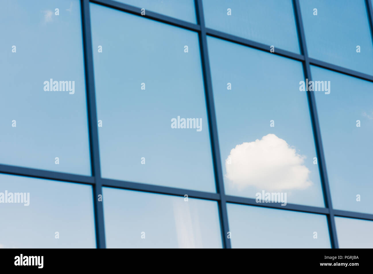 Sky and clouds reflection in the windows of modern office building ...