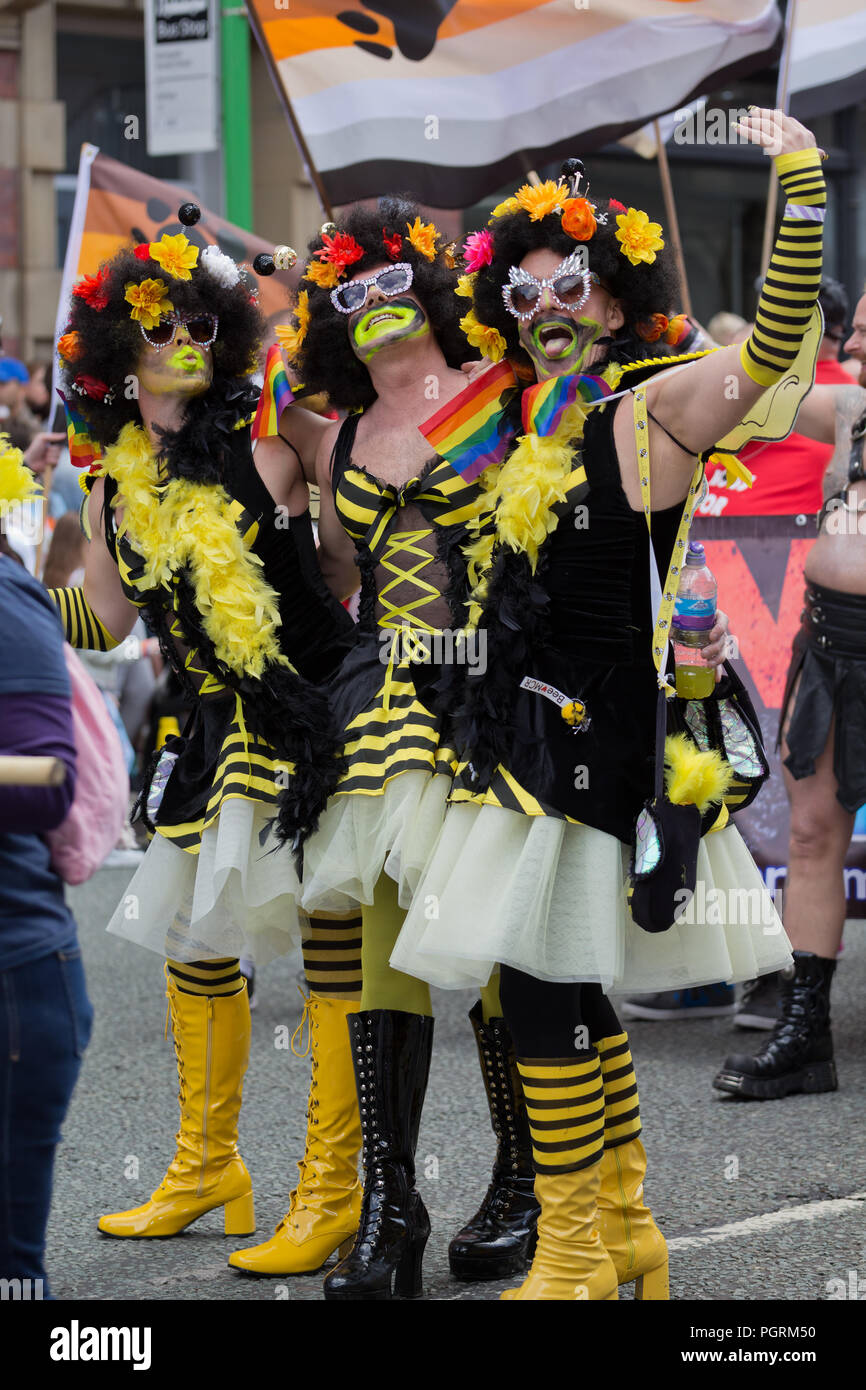 3 men in bee coloured drag costumes whilst taking part in the 2018 Manchester Pride Parade. Stock Photo